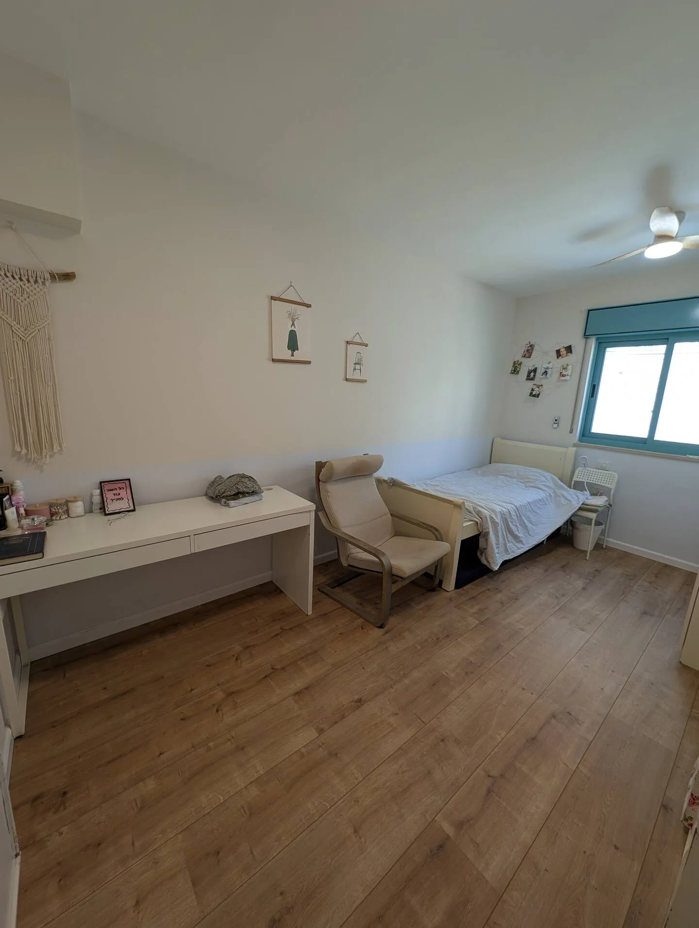 Bedroom with a single bed and a low bench.