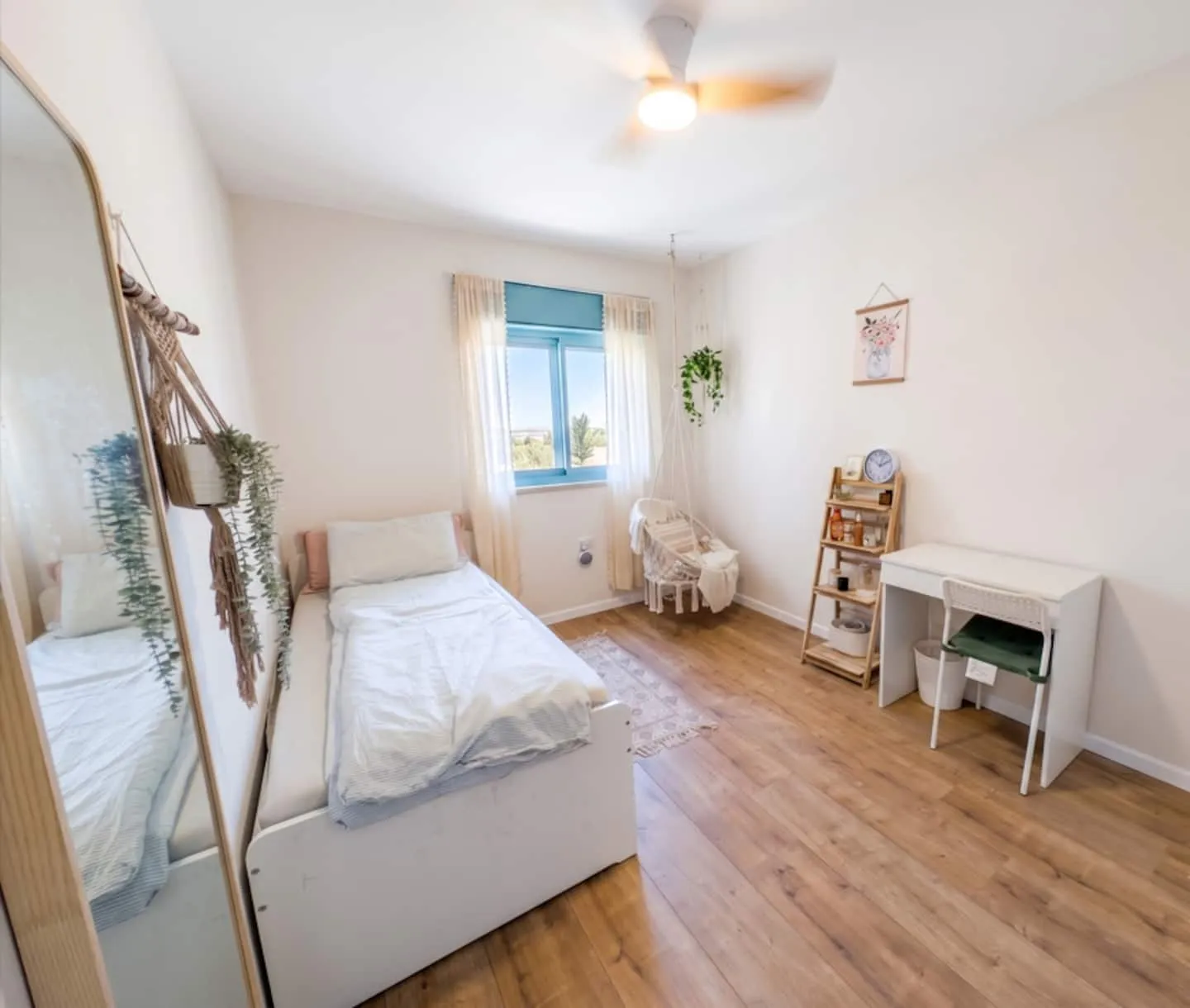 Bedroom with a single bed beside a window and a wall-mounted air conditioner.